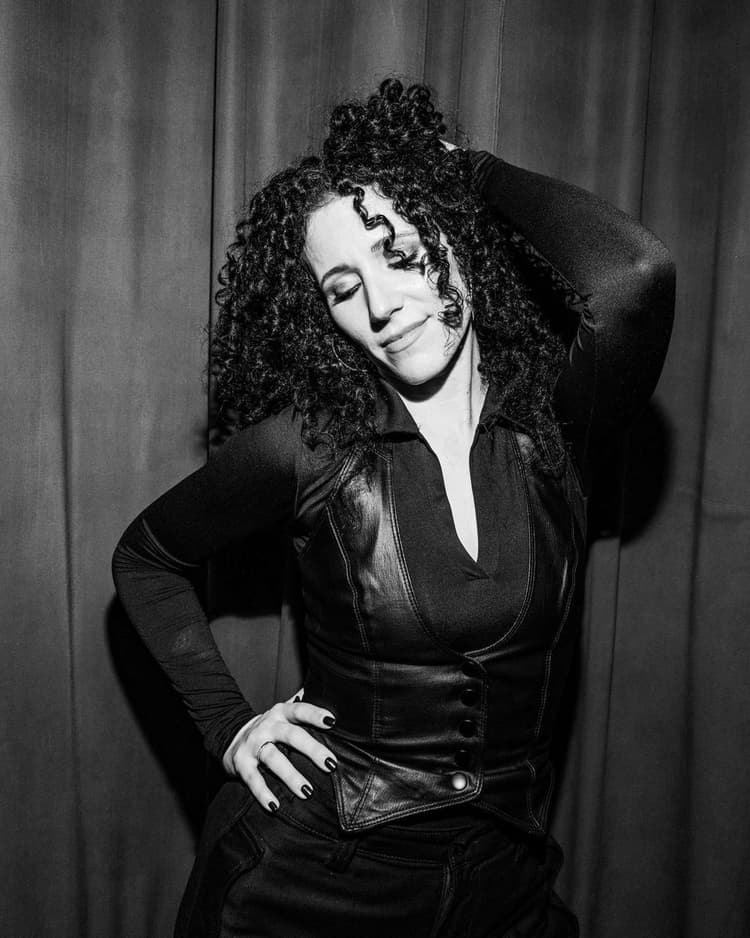 Black and white stage portrait, leather vest