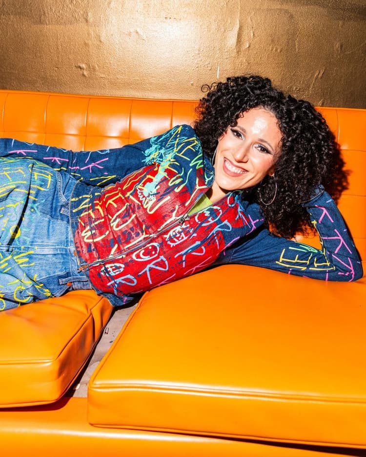 Ali lounging on an orange couch, Nublu shoot